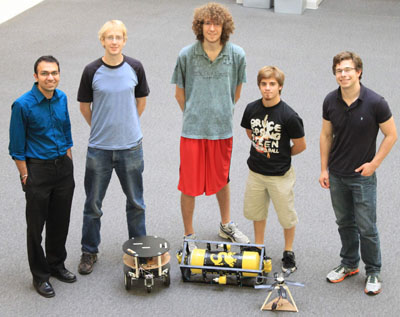 Standing from left to right with the underwater robot:  Dr. Pramod Abichandani, Sean Wagoner, Cezary Mlynarz, Damien Turchi, Ian Wynyard
